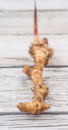 Galangal or Lengkuas roots over wooden backgroundの写真素材