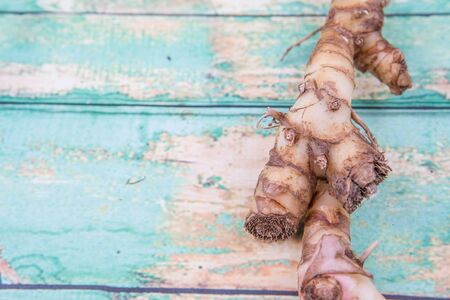 Galangal or Lengkuas roots over wooden backgroundの写真素材
