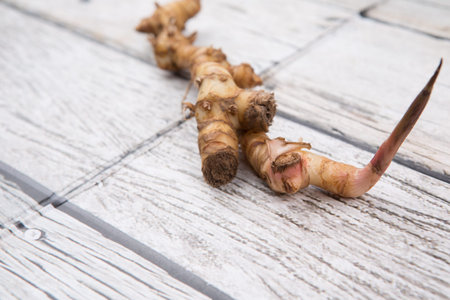 Galangal or Lengkuas roots over wooden backgroundの写真素材