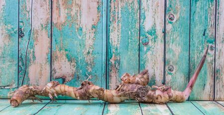 Galangal or Lengkuas roots over wooden backgroundの写真素材