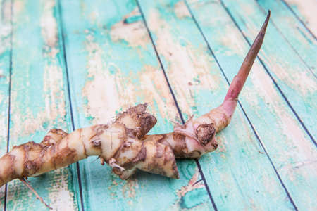 Galangal or Lengkuas roots over wooden backgroundの写真素材