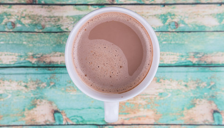 A mug of hot chocolate over wooden backgroundの写真素材