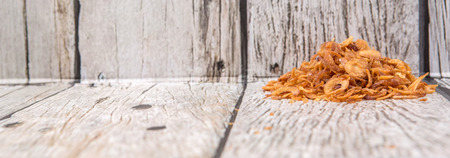Deep fried shallots for garnishing over wooden backgroundの写真素材