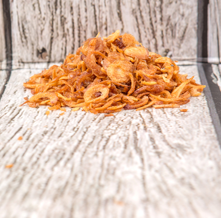 Deep fried shallots for garnishing over wooden backgroundの写真素材