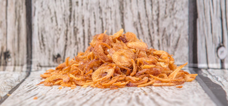Deep fried shallots for garnishing over wooden backgroundの写真素材
