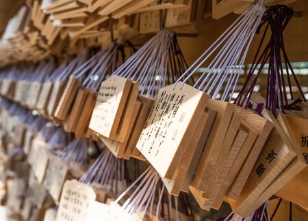 TOKYO, JAPAN - AUGUST 16TH 2015. Prayers written on wooden card called ema in Japanese language at the Meiji Shinto Shrine, Shibuya, Japan.のeditorial素材