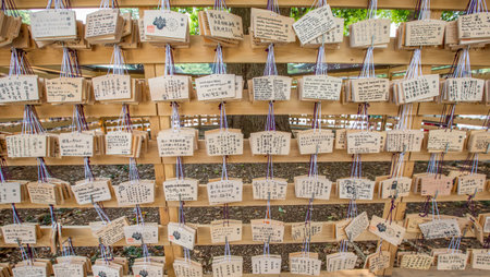 TOKYO, JAPAN - AUGUST 16TH 2015. Prayers written on wooden card called ema in Japanese language at the Meiji Shinto Shrine, Shibuya, Japan.のeditorial素材