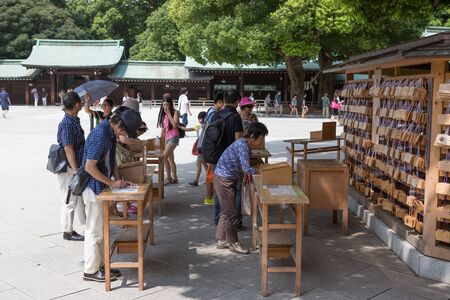 TOKYO, JAPAN - AUGUST 16TH 2015. Prayers written on wooden card called ema in Japanese language at the Meiji Shinto Shrine, Shibuya, Japan.のeditorial素材
