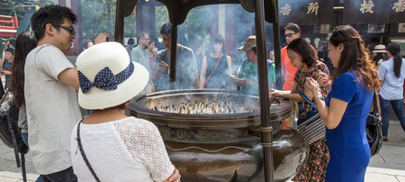 ASAKUSA, TOKYO, JAPAN - AUGUST 22ND, 2015: Worshippers and tourists at Sensoji Shrine, Asakusa, Tokyo. Founded in 645 CE, Sensoji shrine is an ancient Buddhist temple and Tokyo's oldest temple.のeditorial素材