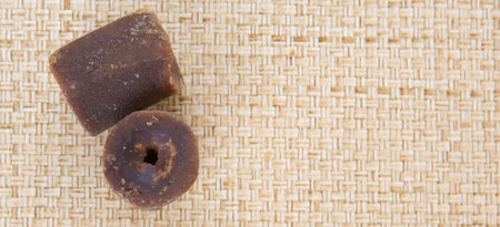Coconut palm sap sugar or locally know as gula melaka over wicker background