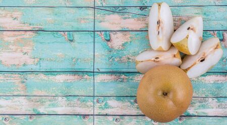 Asian pear, also known as Nashi pear over wooden backgroundの写真素材