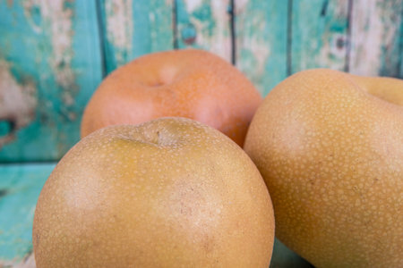 Asian pear, also known as Nashi pear over wooden backgroundの写真素材
