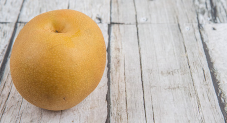 Asian pear, also known as Nashi pear over wooden backgroundの写真素材