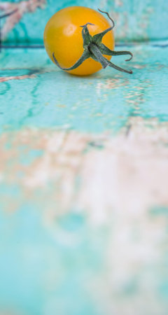 Mini yellow cherry tomato over wooden backgroundの写真素材