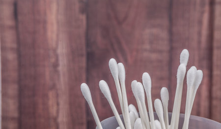 White cotton bud or cotton swab over wooden backgroundの写真素材