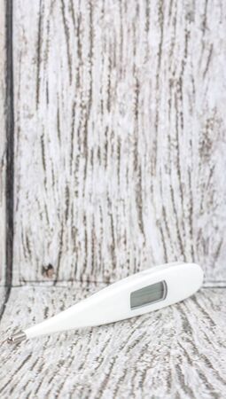 Medical thermometer over wooden backgroundの写真素材