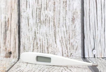 Medical thermometer over wooden backgroundの写真素材
