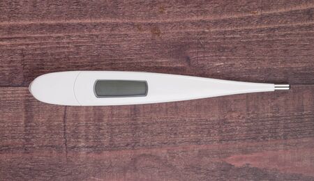 Medical thermometer over wooden backgroundの写真素材