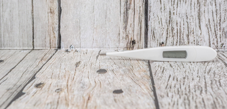 Medical thermometer over wooden backgroundの写真素材