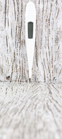 Medical thermometer over wooden backgroundの写真素材