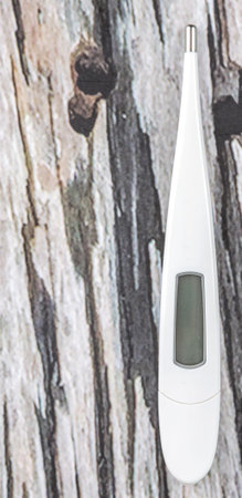 Medical thermometer over wooden background