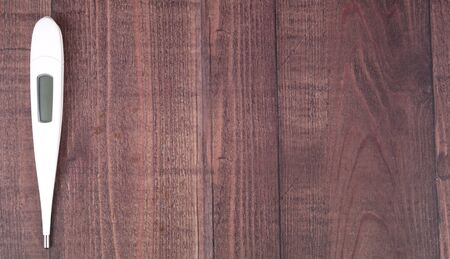 Medical thermometer over wooden backgroundの写真素材