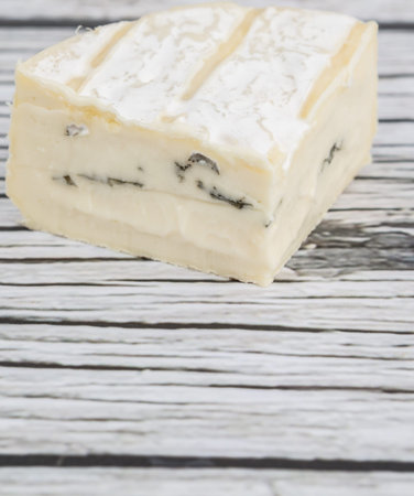 Blue cheese over wooden background