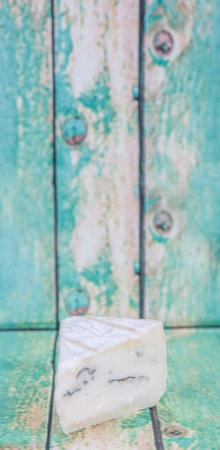 Blue cheese over wooden backgroundの写真素材