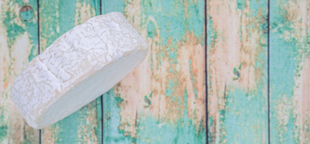 Blue cheese over wooden backgroundの写真素材
