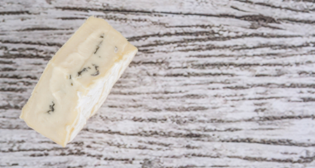 Blue cheese over wooden backgroundの写真素材