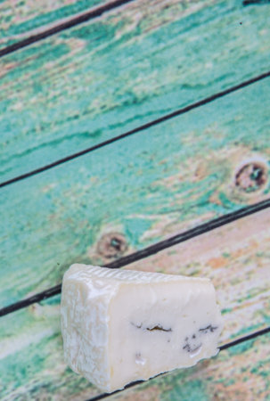 Blue cheese over wooden backgroundの写真素材