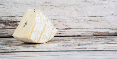 Blue cheese over wooden backgroundの写真素材