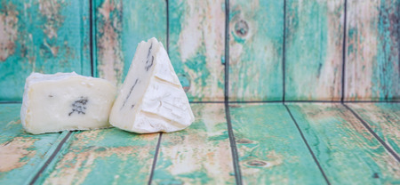 Blue cheese over wooden backgroundの写真素材