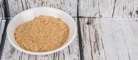 Lemongrass powder in a white bowl over wooden backgroundの写真素材