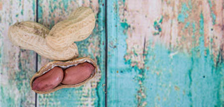 Peanut or ground nut over wooden backgroundの写真素材