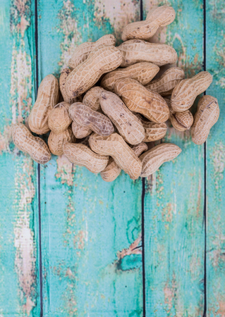 Peanut or ground nut over wooden backgroundの写真素材