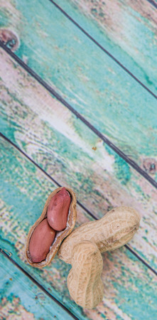Peanut or ground nut over wooden backgroundの写真素材