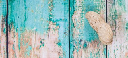 Peanut or ground nut over wooden backgroundの写真素材