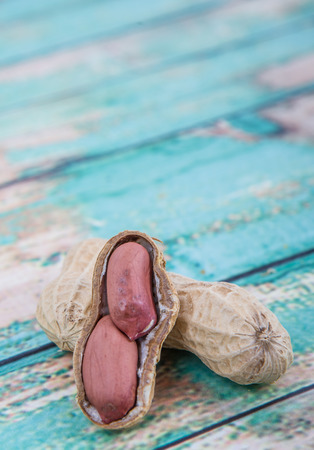 Peanut or ground nut over wooden backgroundの写真素材