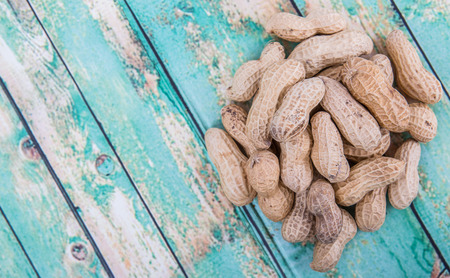 Peanut or ground nut over wooden backgroundの写真素材
