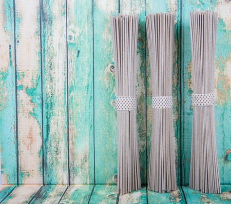 Dried raw soba noodle stick over wooden backgroundの写真素材