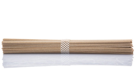 Dried raw Japanese soba noodle stick over white background