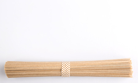 Dried raw Japanese soba noodle stick over white backgroundの写真素材