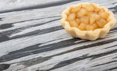 Mini apple pie over wooden backgroundの写真素材
