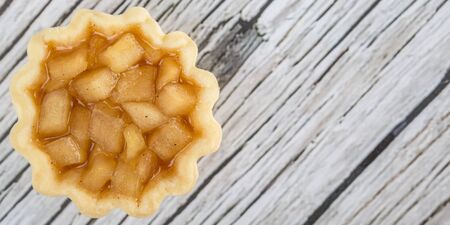 Mini apple pie over wooden backgroundの写真素材