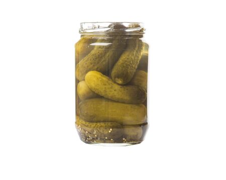 Dill pickle in a glass jar over white backgroundの写真素材