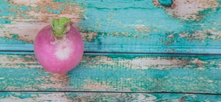 Small pink radish vegetable over wooden backgroundの写真素材