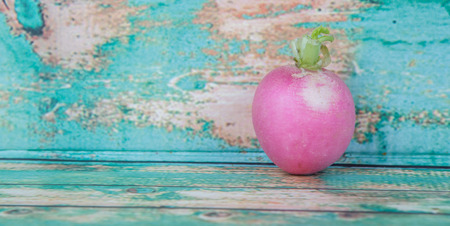 Small pink radish vegetable over wooden backgroundの写真素材