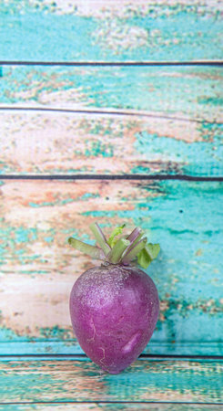Small purple radish vegetable over wooden background