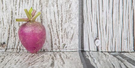 Small purple radish vegetable over wooden backgroundの写真素材